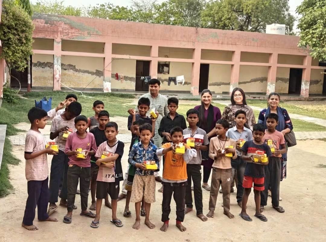 Children and AAS India Foundation team members during a community support activity